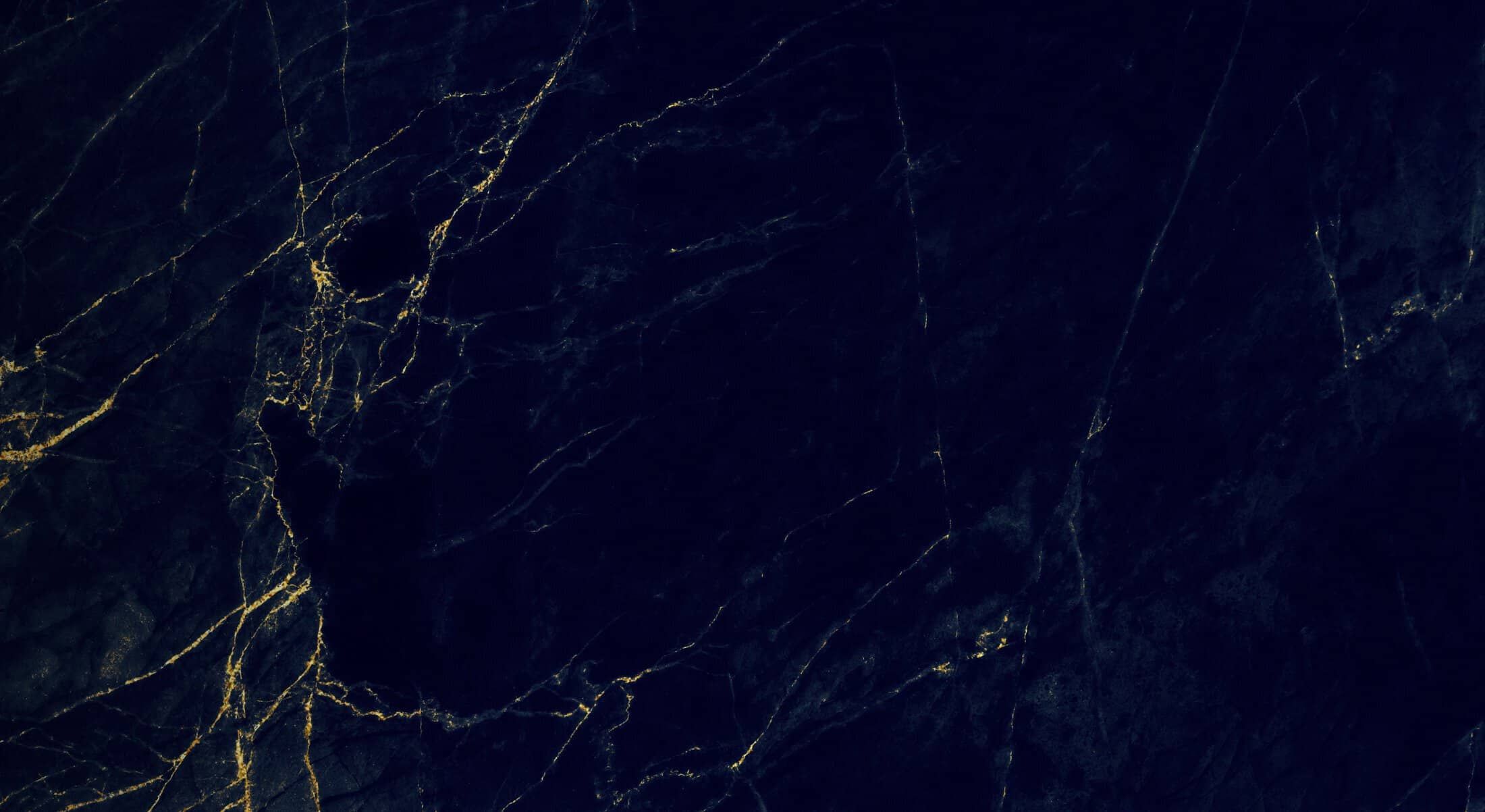 Dark marble texture with golden veining.