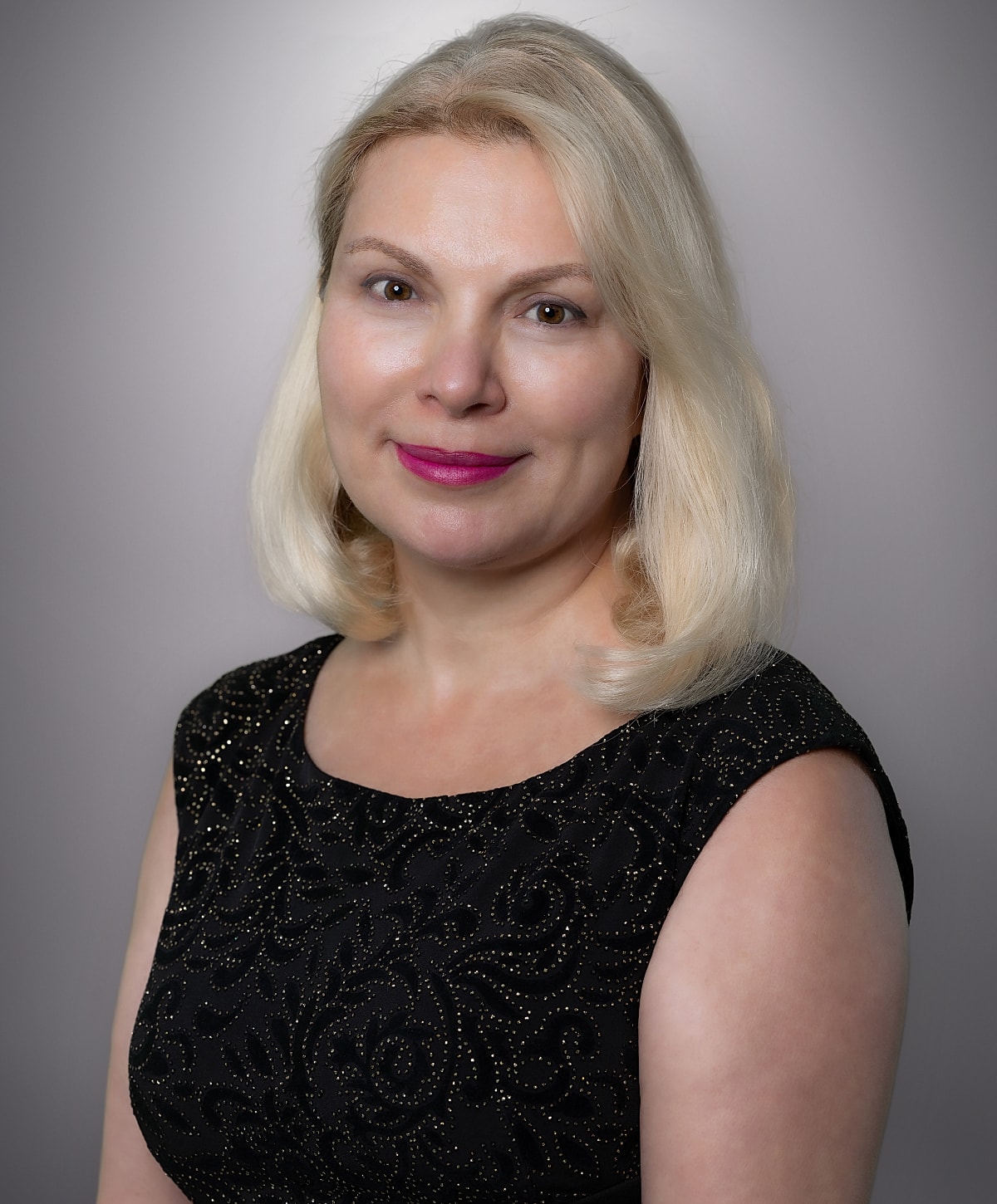 Professional portrait of a woman with blonde hair.