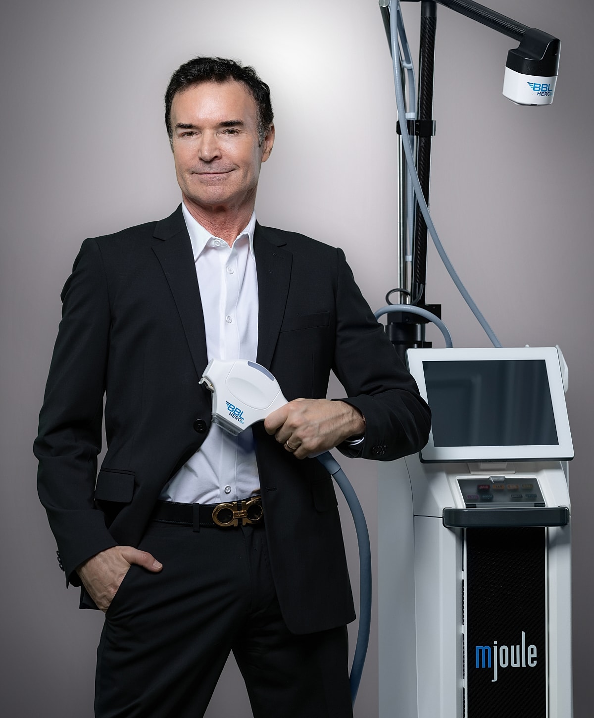 Man in suit with medical device.