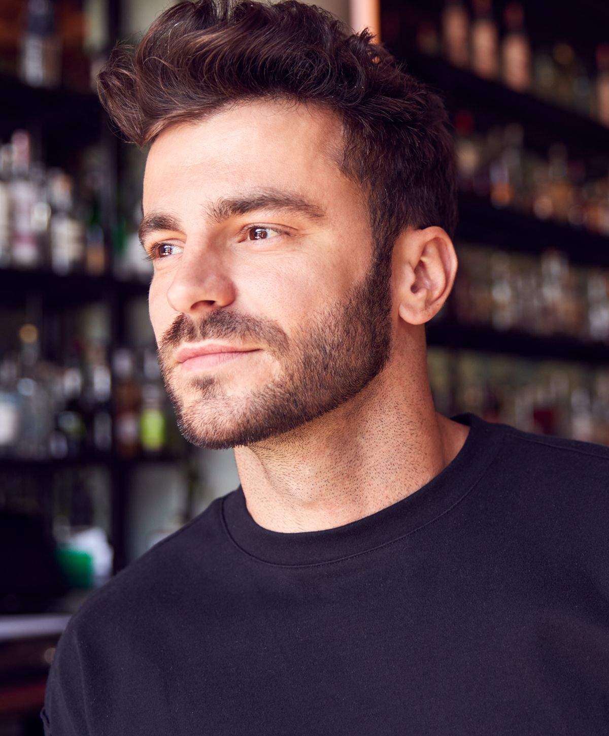 Man with short dark hair and beard smiling.