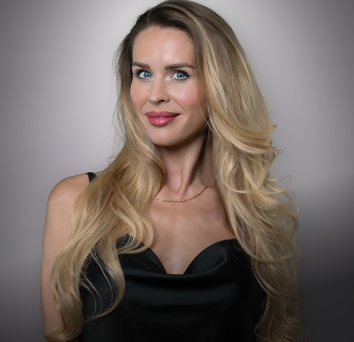 Woman with long blonde hair and blue eyes.