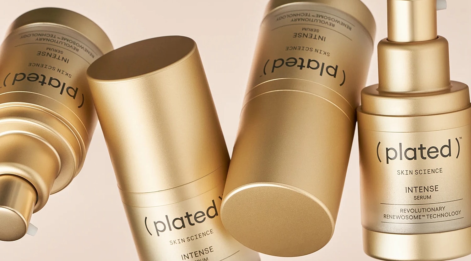 Gold skincare serum containers on a light background