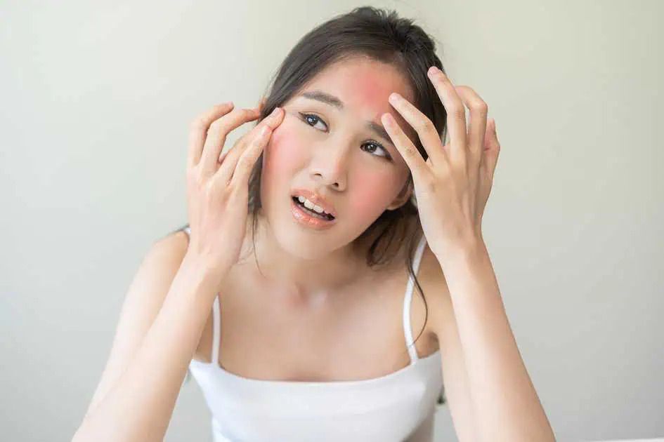 Woman experiencing skin irritation or discomfort.