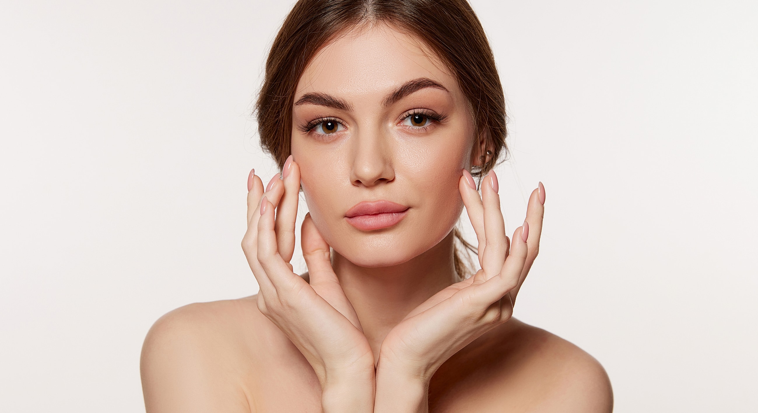 Woman gently touching her face, natural beauty.