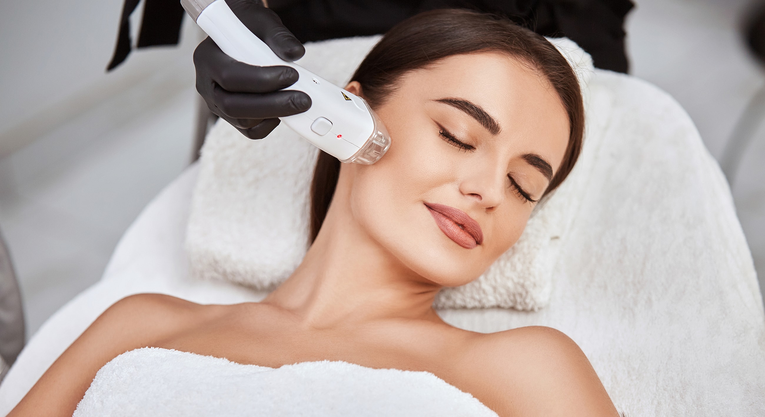Woman receiving a facial treatment in spa.
